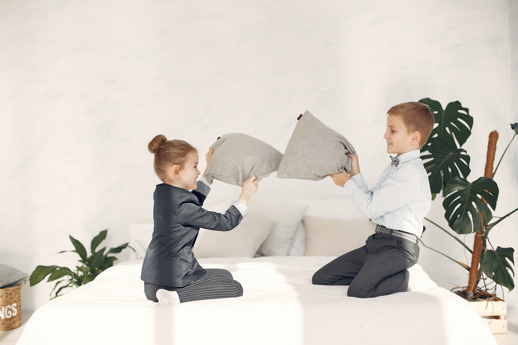 Children at home fight pillows